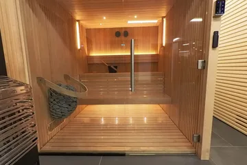 Auroom Libera Glass, on the showroom floor: The Libera Glass with its door open, the heaters on display beside it.