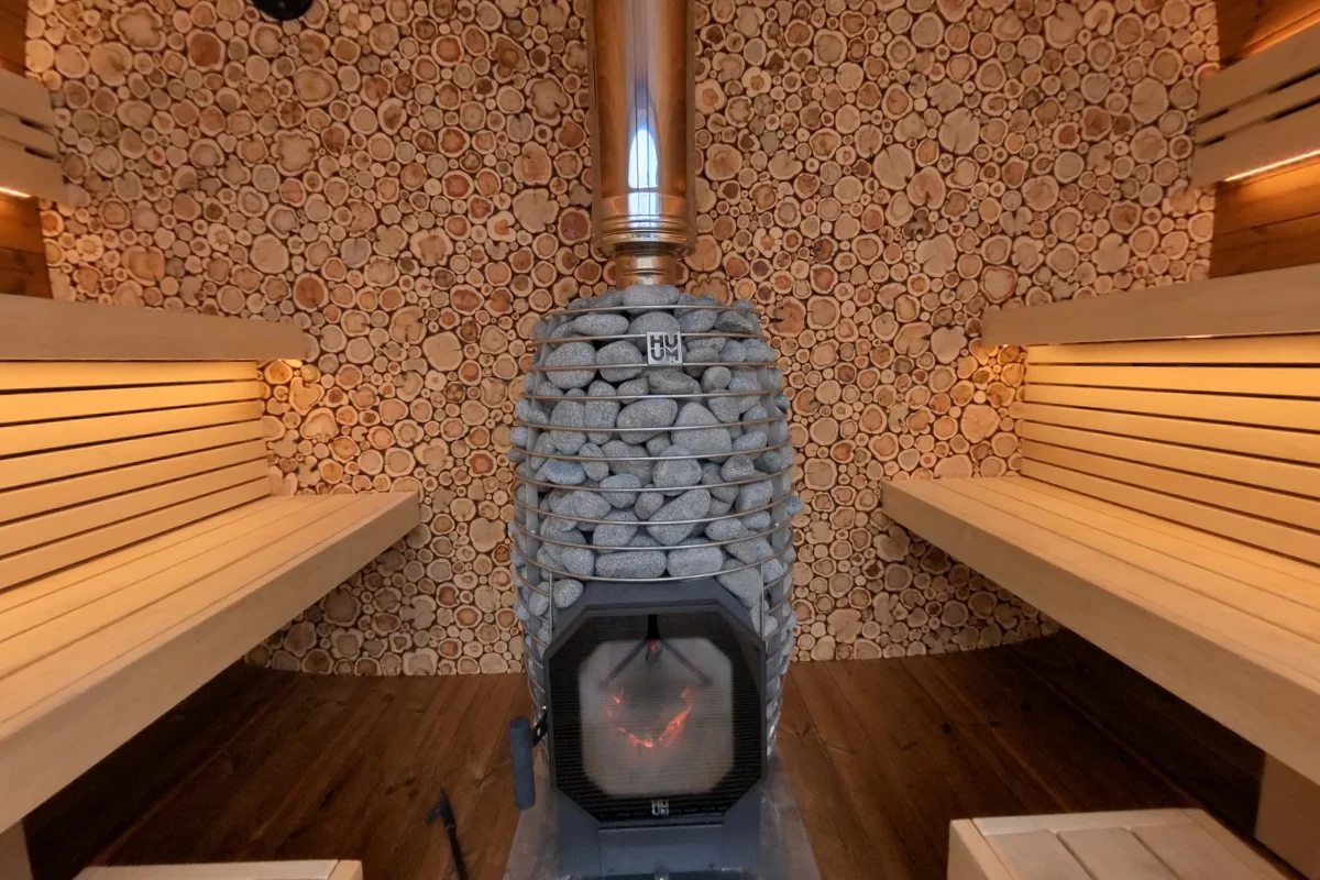 Opposing Round Cube Single benches with the stove at the rear.