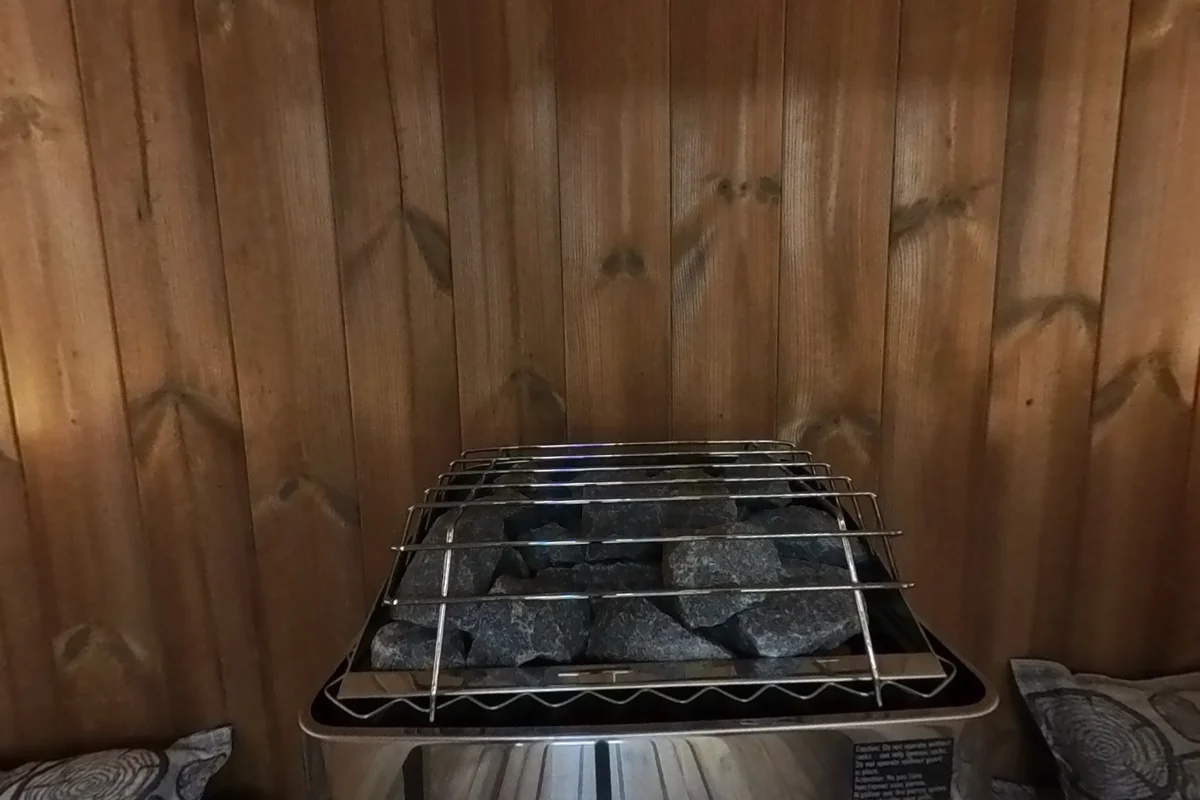 Stone heater at the rear of the E7G between the bench ends.