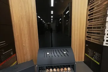Saunum Heater display, air column: The air column and salt-ball tray from the showroom aisle.