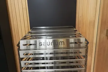 Saunum Heater display, open basket: A closer view of the open-basket heater and air column.