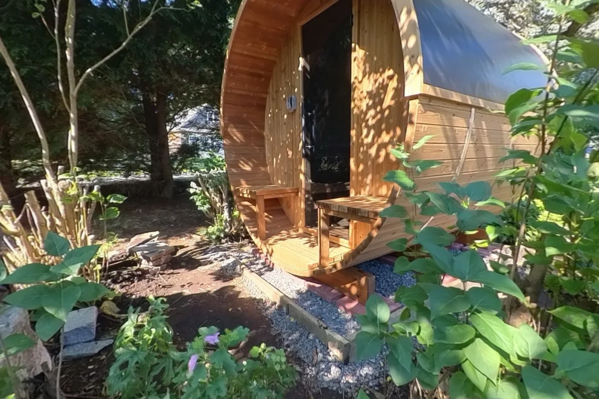 Completed Thermory barrel installation with porch and rear-window layout.