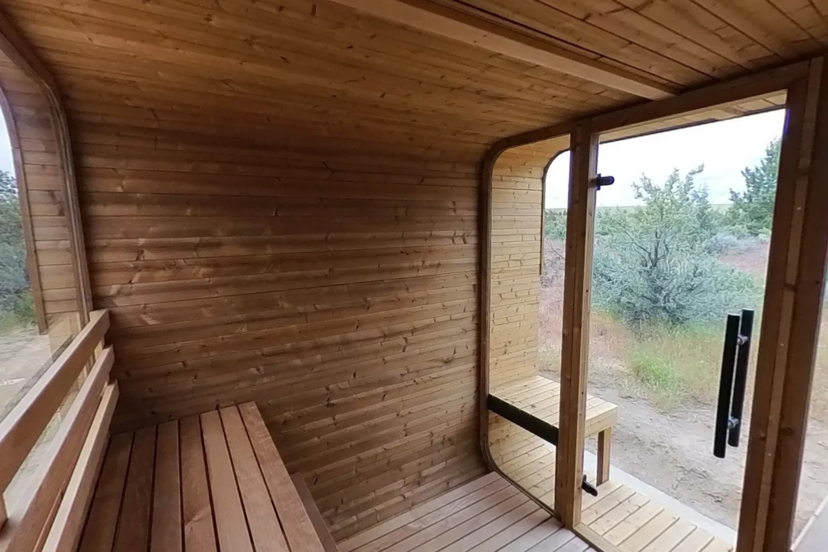 The Square side bench runs between the glass-door end and the rear-window end of the sauna.